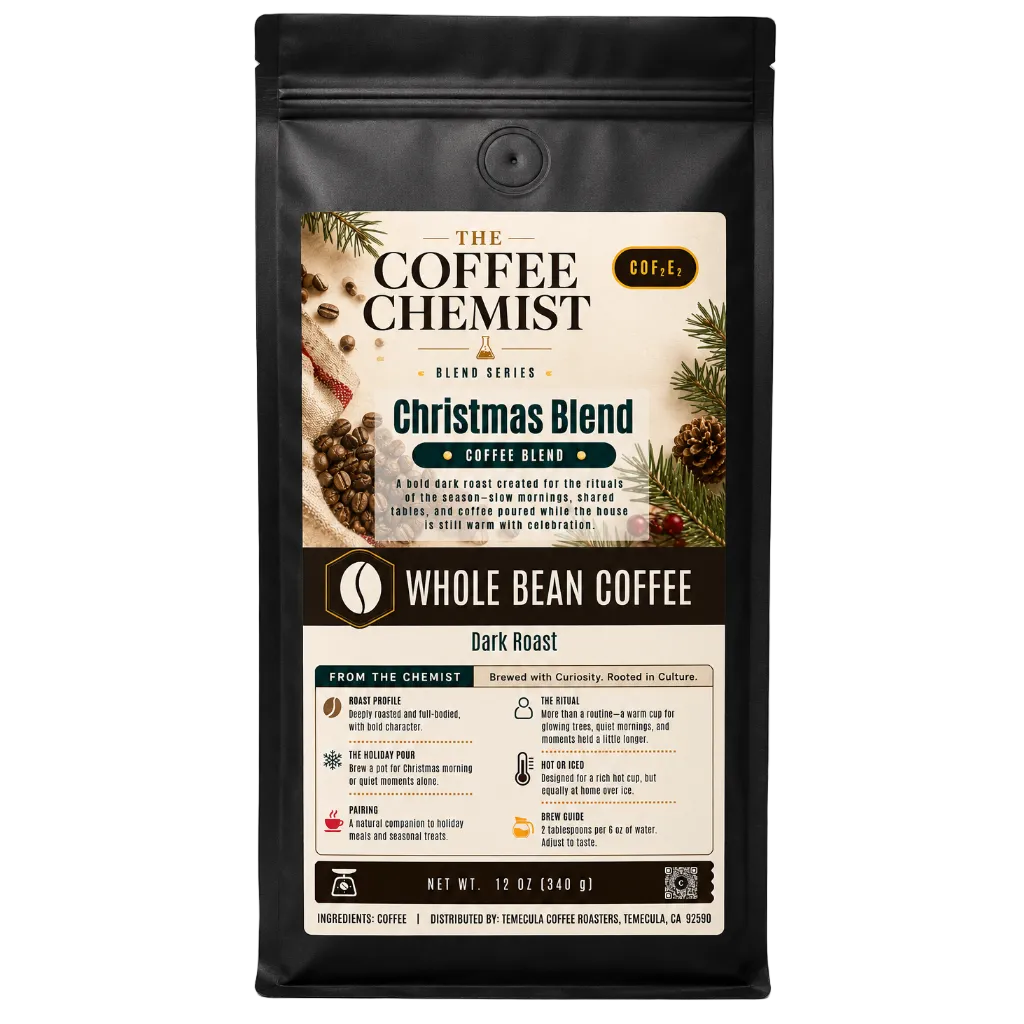 A 12 oz bag of The Coffee Chemist Christmas Blend whole bean coffee, dark roast, in a black resealable stand-up pouch with a detailed holiday-themed label.