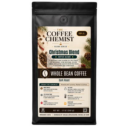 A 12 oz bag of The Coffee Chemist Christmas Blend whole bean coffee, dark roast, in a black resealable stand-up pouch with a detailed holiday-themed label.